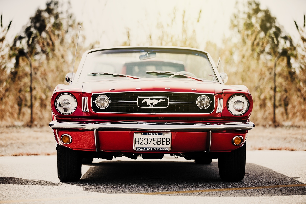 Classic Ford Mustang convertible parked outdoors. Vintage filter.